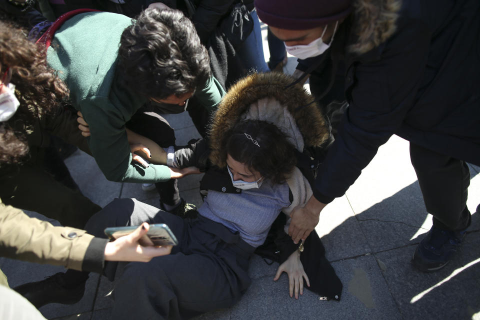 Turkish police officers apprehend a protester during a demonstration in Istanbul, Saturday, March 27, 2021, against Turkey's withdrawal from Istanbul Convention, an international accord designed to protect women from violence. The Istanbul Convention states that men and women have equal rights and obliges national authorities to take steps to prevent gender-based violence against women, to protect victims and to prosecute perpetrators. Conservative groups and some officials from Turkeys President Recep Tayyip Erdogan's Islamic-oriented ruling party take issue with these terms, saying they promote homosexuality. (AP Photo/Emrah Gurel)