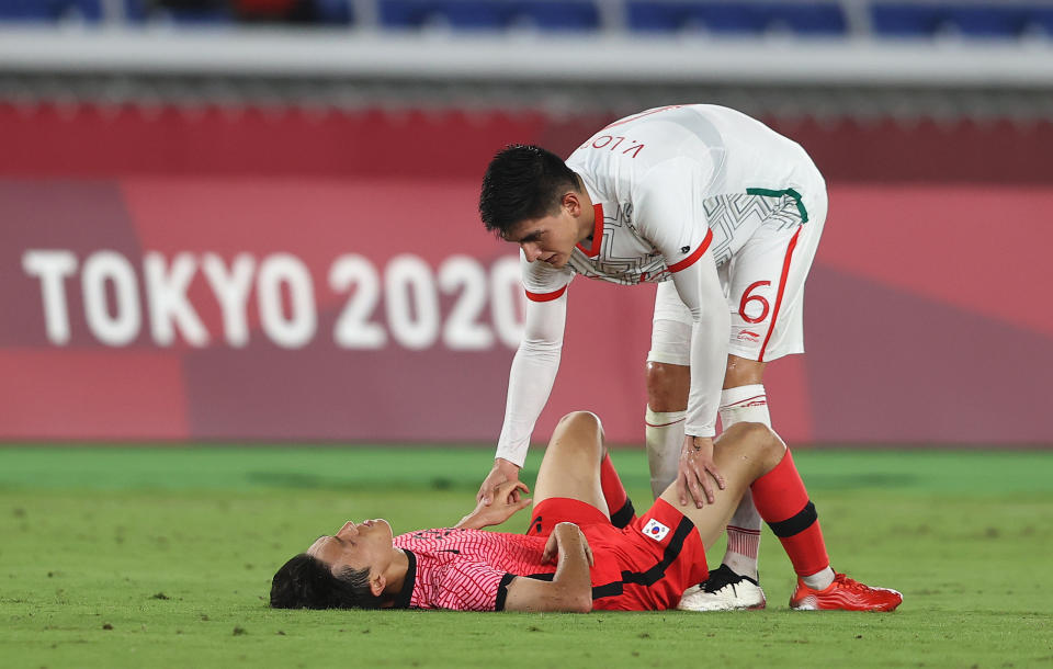 YOKOHAMA, JAPAN - JULY 31: Jinya Kim #13 of Team South Korea is consoled by Vladimir Lorona #6 of Team Mexico following defeat in the Men's Quarter Final match between Republic Of Korea and Mexico on day eight of the Tokyo 2020 Olympic Games at International Stadium Yokohama on July 31, 2021 in Yokohama, Kanagawa, Japan. (Photo by Francois Nel/Getty Images)