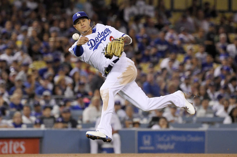 Los Angeles Dodgers shortstop Manny Machado throws out San Francisco Giants' Andrew McCutchen during the fifth inning of a baseball game Tuesday, Aug. 14, 2018, in Los Angeles. (AP Photo/Mark J. Terrill)