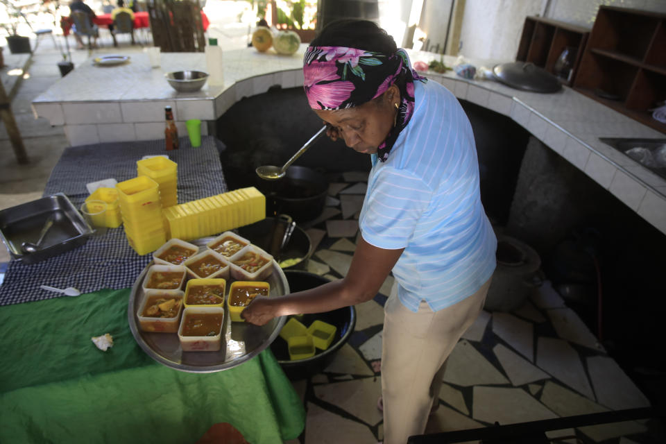 Mireille Lerebours serves traditional soup joumou at a restaurant in the Delmas district of Port-au-Prince, Haiti, Sunday, Feb. 5, 2023. In 2021, the same year the country spiraled into chaos following the assassination of its president, the soup was added to UNESCO’s Intangible Cultural Heritage List, the first cuisine Haiti has on the list. (AP Photo/Odelyn Joseph)