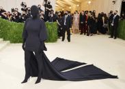 At first, no one quite understood Kim Kardashian's head-to-toe black ensemble from Balenciaga at the 2021 Met Gala. It caused much confusion throughout the night, and, aside from memes galore, theories erupted throughout Twitter. While no solid inspiration was confirmed, many began to think: The theme is American fashion history at all, and what's more iconic in American fashion than Kim's silhouette? Her shadow is, quite literally, history. (On her <a href="https://www.instagram.com/p/CT0ArT4FhJI/" rel="nofollow noopener" target="_blank" data-ylk="slk:Instagram;elm:context_link;itc:0;sec:content-canvas" class="link ">Instagram</a>, Kim offered an alternative take: "What’s more American than a T-shirt head to toe?!")