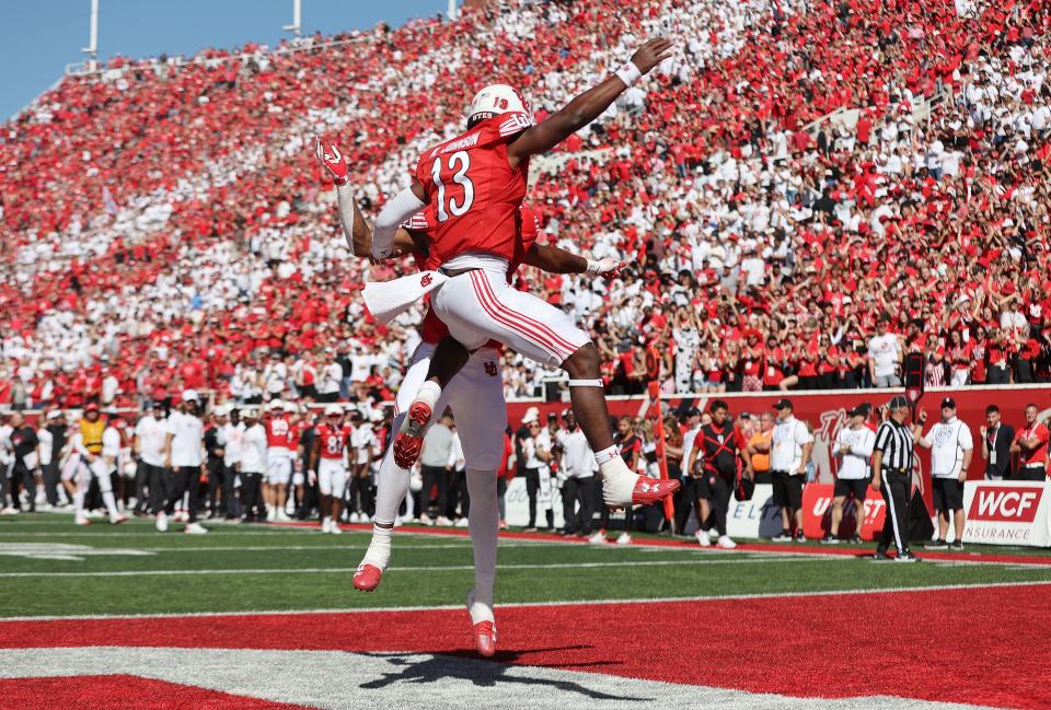 Utah Utes quarterback Nate Johnson (13) celebrates a touchdown with Utah Utes receiver Landen King (82) in Salt Lake City on Saturday, Sept. 23, 2023.