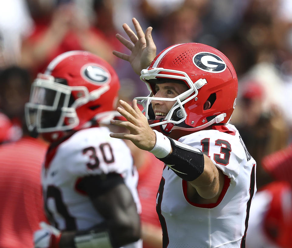 Georgia quarterback Stetson Bennett celebrates his touchdown pass to tight end Brock Bowers that went for 70-plus yards during the third quarter of a NCAA college football game against South Carolina in Columbia, S.C., Saturday, Sept. 17, 2022. (Curtis Compton/Atlanta Journal-Constitution via AP)