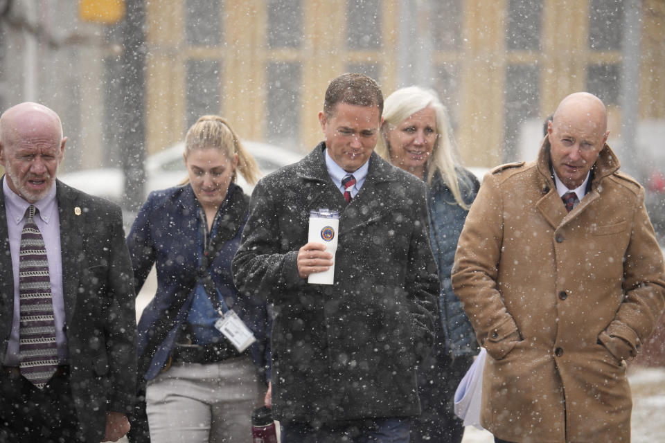 Michael J. Allen, district attorney for Colorado's Fourth Judicial District, front center, leads a contingent of lawyers back into the El Paso County courthouse after a lunch break in a preliminary hearing for the alleged shooter in the Club Q mass shooting Wednesday, Feb. 22, 2023, in Colorado Springs, Colo. (AP Photo/David Zalubowski)