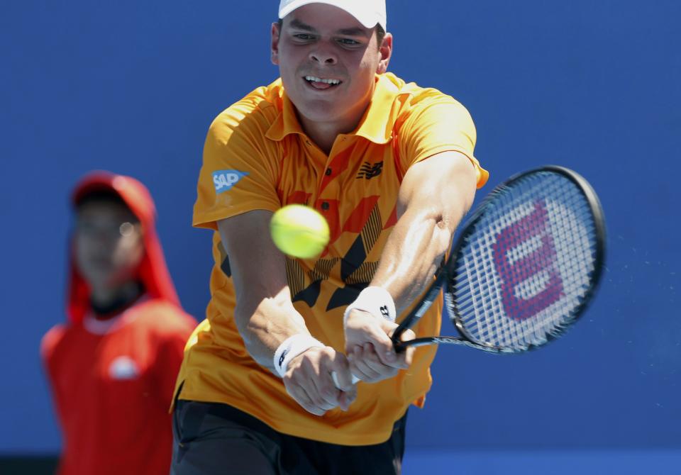 Milos Raonic of Canada hits a return to Daniel Gimeno-Traver of Spain during their men's singles match at the Australian Open 2014 tennis tournament in Melbourne January 14, 2014. REUTERS/Brandon Malone (AUSTRALIA - Tags: SPORT TENNIS)