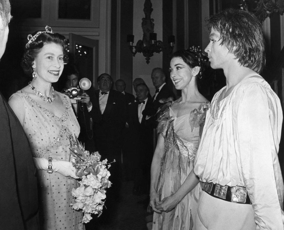 <p>A young Queen Elizabeth II appears here with Rudolph Nureyev and Dame Margot Fonteyn in 1969.</p>