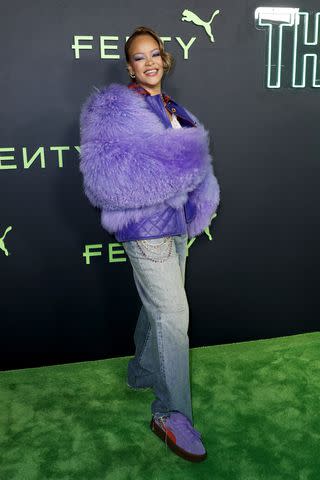 <p>Frazer Harrison/Getty</p> Rihanna wears vibrant purple jacket