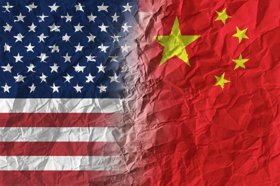 American and Chinese flags on crumpled paper, diplomatic crisis