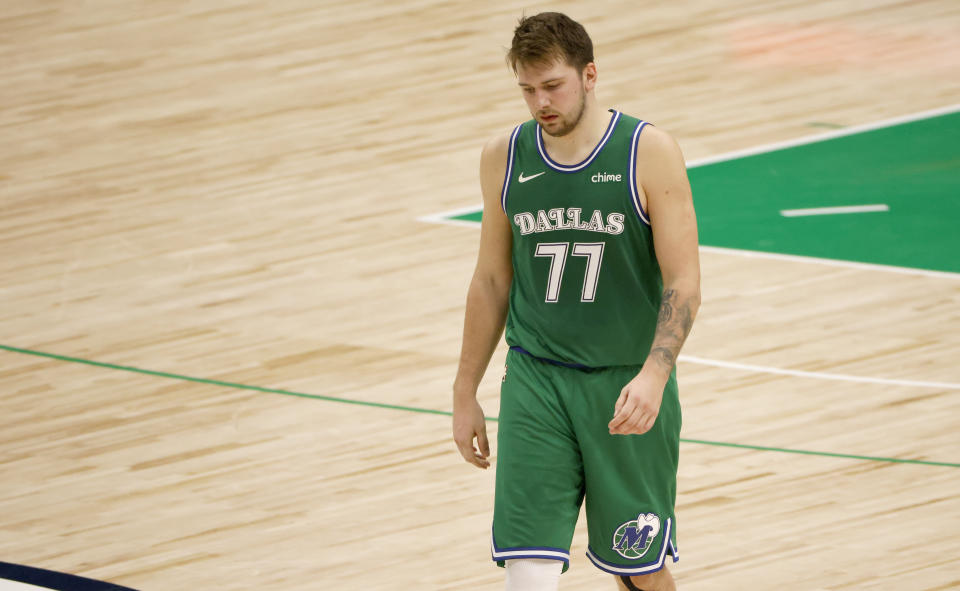 Dallas Mavericks guard Luka Doncic walks to the bench during a timeout in the second half of the team's NBA basketball game against the New York Knicks, Friday, April 16, 2021, in Dallas. (AP Photo/Ron Jenkins)