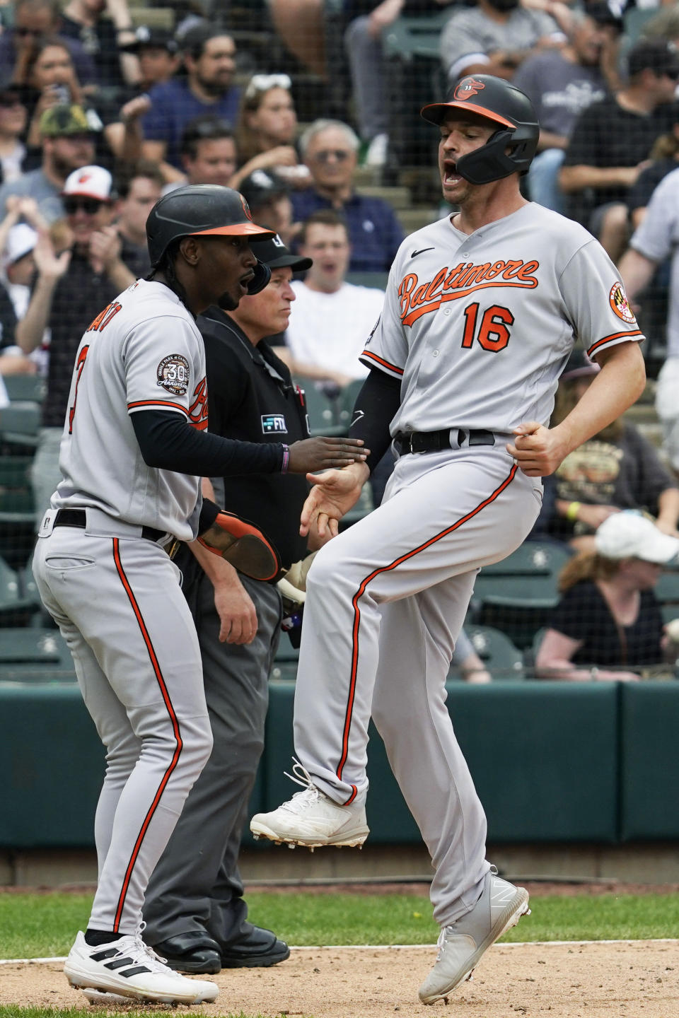 Baltimore Orioles' Trey Mancini, right, celebrates with Jorge Mateo after scoring on a three-run double by Austin Hays during the seventh inning of a baseball game against the Chicago White Sox in Chicago, Saturday, June 25, 2022. (AP Photo/Nam Y. Huh)