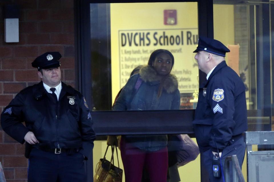 Studenta leave the Delaware Valley Charter School Friday, Jan. 17, 2014, in Philadelphia. Police say two students have been shot at a Philadelphia high school. (AP Photo/Matt Rourke)