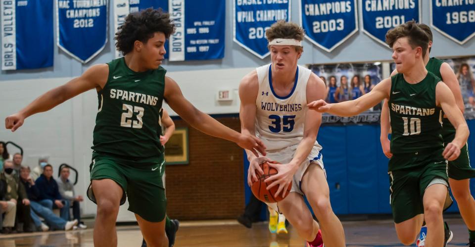 Ellwood City's Joseph Roth goes to the basket against Laurel's Kobe DeRosa (23) and Landon Smith (10) Tuesday at Lincoln High School.