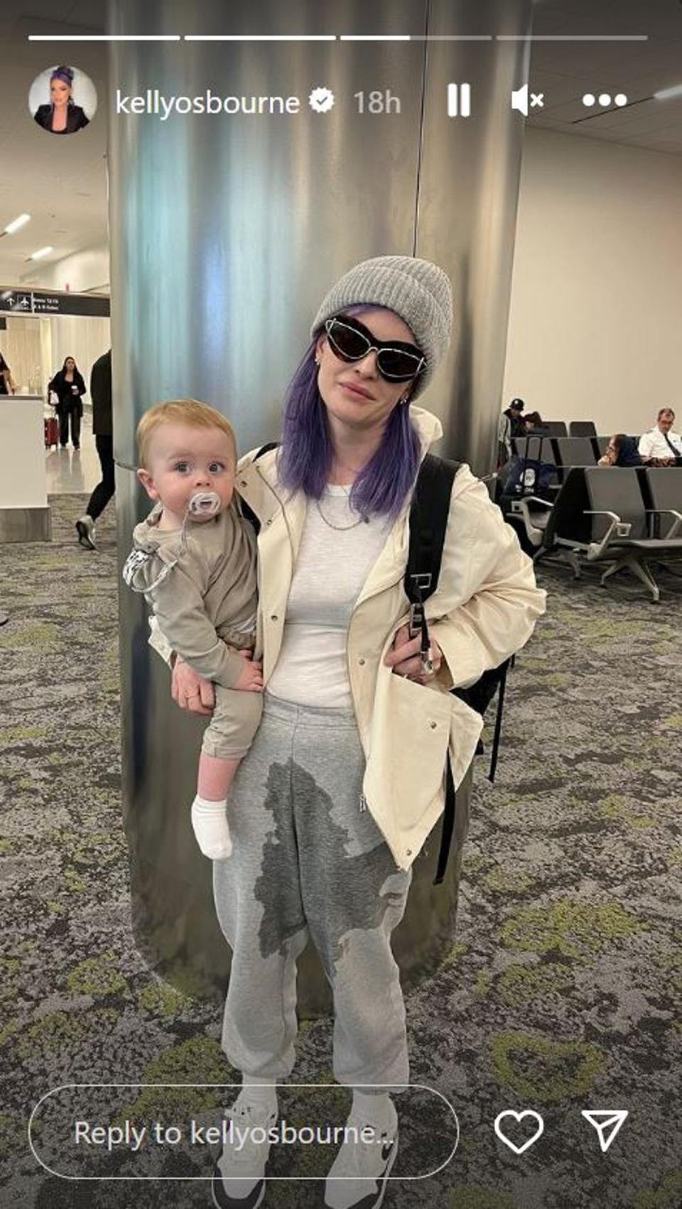Kelly Osbroune posed with baby Sidney and her vomit-soaked jogging bottoms in all of their glory (Kelly Osbourne Instagram)