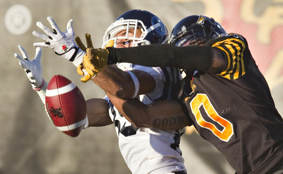 Tiger-Cats Murray breaks up a pass to Argonauts Watt in the first half of their CFL game in Guelph