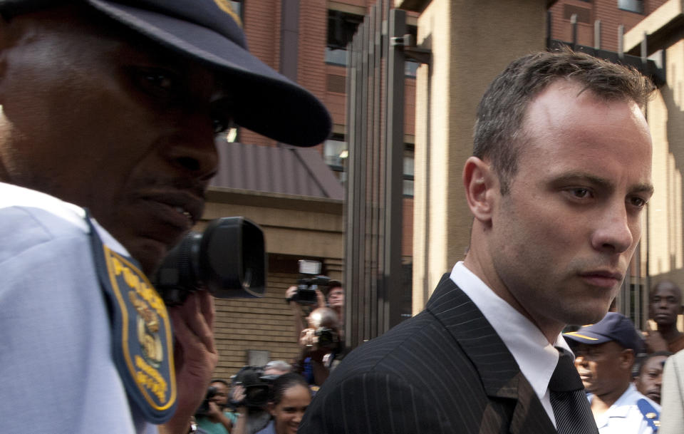 Oscar Pistorius leaves the high court in Pretoria, South Africa, Tuesday, March 18, 2014. Pistorius is charged with murder for the shooting death of his girlfriend, Reeva Steenkamp, on Valentines Day in 2013. (AP Photo/Themba Hadebe)