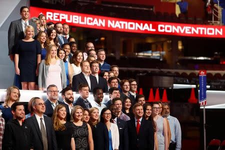 Members of the Committee on Arrangements pose for a photo on the stage at Quicken Loans Arena as setup continues in advance of the Republican National Convention in Cleveland, Ohio July 16, 2016. REUTERS/Aaron P. Bernstein