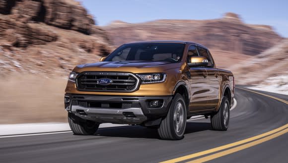 A bronze-colored 2019 Ford Ranger, a midsize pickup truck, on a mountain road.