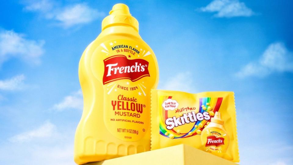 A bottle of French's Mustard next to a bag of Mustard Skittles