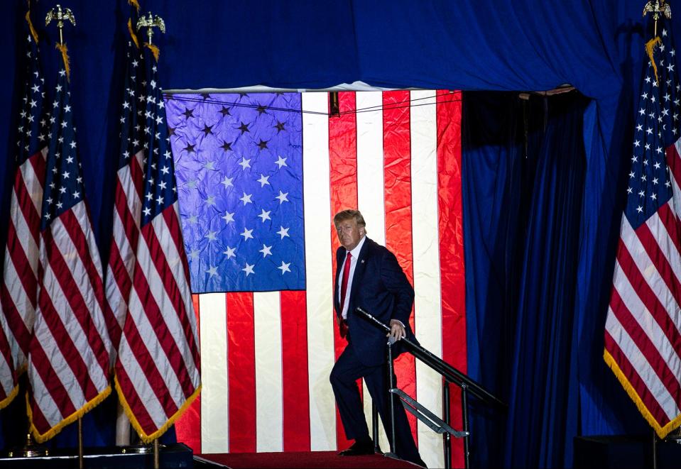 Former President Donald Trump takes the stage during a Save America rally at the Michigan Stars Sports Center in Washington Township on April 2, 2022.