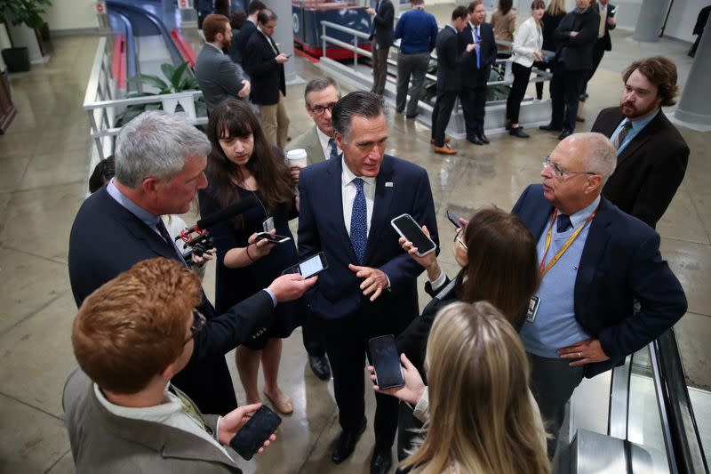 U.S. Senator Romney speaks to reporters as he walks through the subway system at the U.S. Capitol in Washington