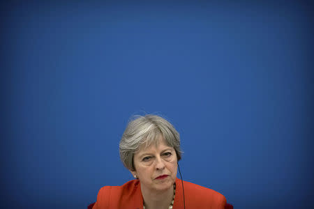 British Prime Minister Theresa May listens to a speaker during the inaugural meeting of the UK-China CEO Council at the Great Hall of the People in Beijing, China January 31, 2018. REUTERS/Mark Schiefelbein/Pool