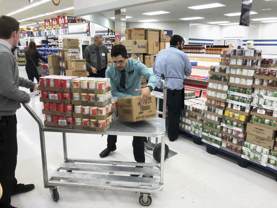 Employees stock products at a Hy-Vee supermarket in Omaha, Neb. (Nati Harnik / AP)