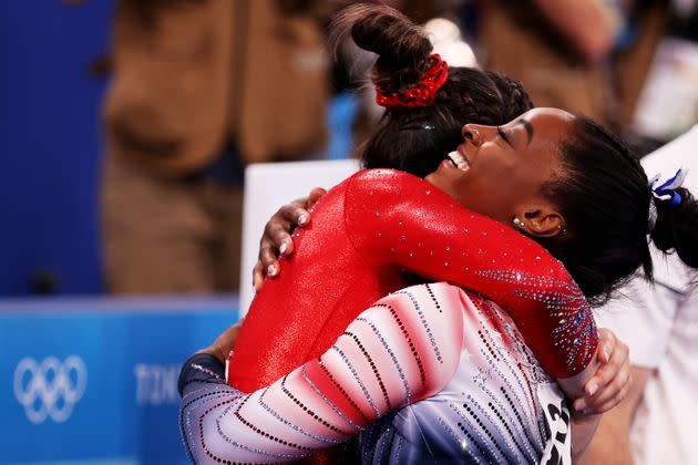 Simone Biles embraces teammate Sunisa Lee during the women's balance beam final. (Photo: Elsa via Getty Images)