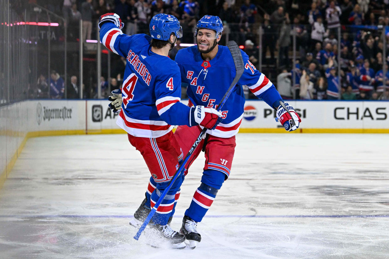 Apr 13, 2024; New York, New York, USA; New York Rangers defenseman K'Andre Miller (79) celebrates the goal by New York Rangers defenseman Braden Schneider (4) against the New York Islanders during the second period at Madison Square Garden.