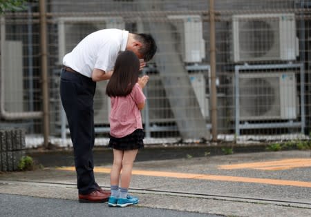 People pray for victims of the torched Kyoto Animation building in Kyoto
