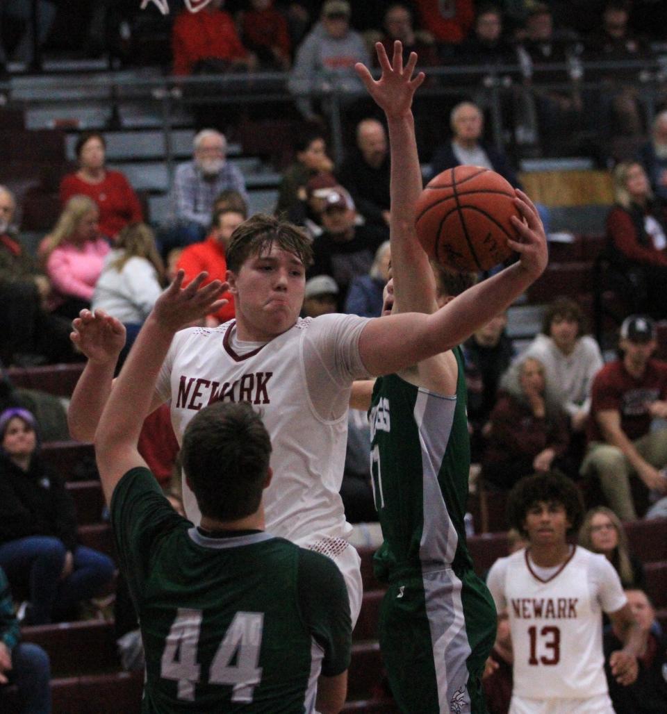 Newark's Steele Meister passes to a teammate after splitting between Northridge defenders on Tuesday.