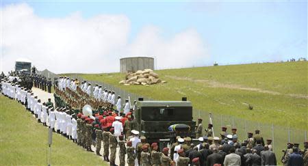 The coffin of South African former president Nelson Mandela is carried on a gun carriage for a traditional burial in after the funeral ceremony in Qunu