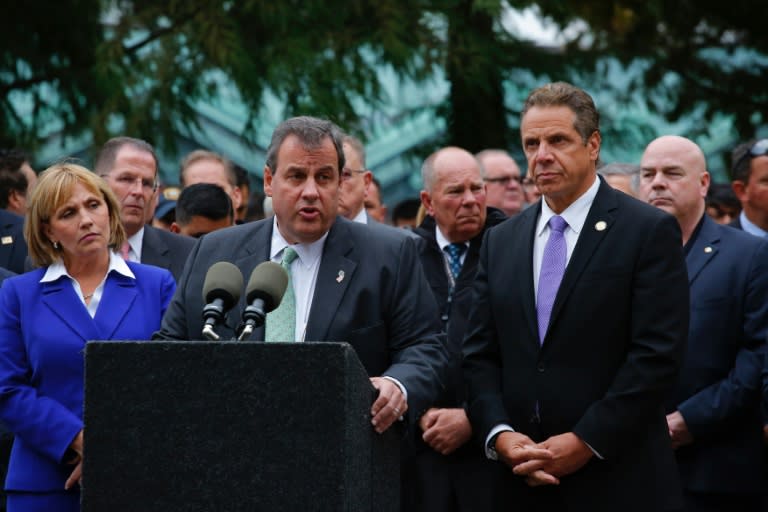 New Jersey Governor Chris Christie (C) and New York Governor Andrew Cuomo (R) address a press conference outside the New Jersey transit rail station in Hoboken on September 29, 2016