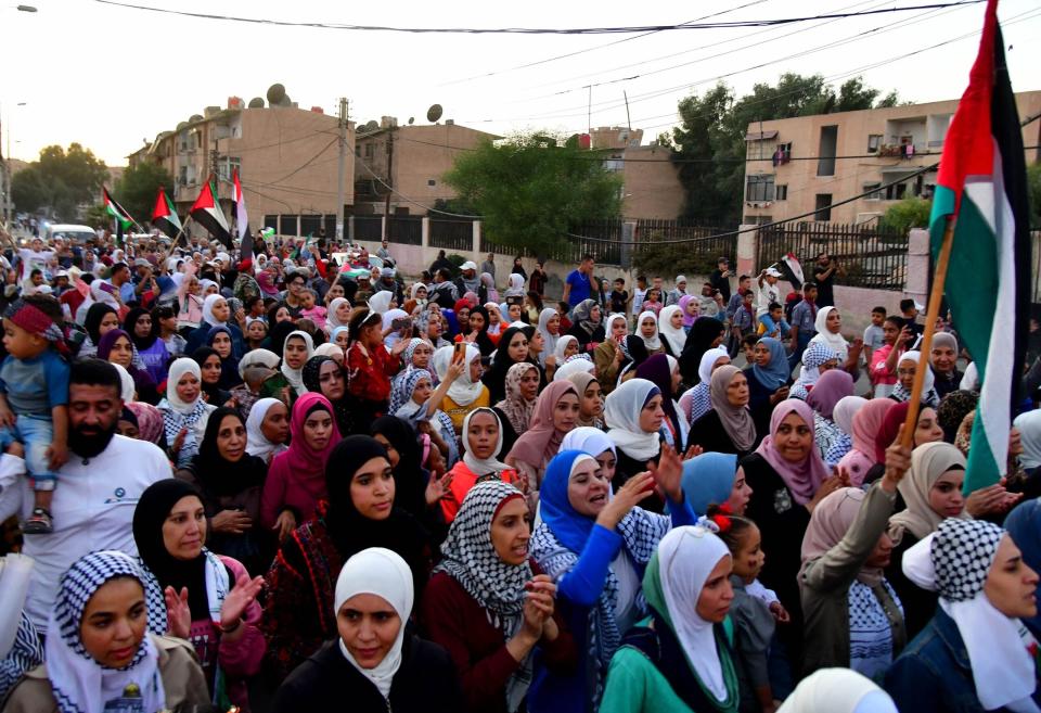 People take part in a protest to condemn Israeli missile strikes on two Syrian airports, and voice their support for the Palestinians, in Damascus, Syria, Oct. 12, 2023. (Photo by Ammar Safarjalani/Xinhua via Getty Images)