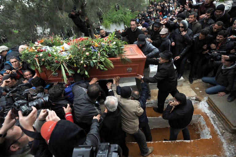 Tunisians carry the coffin of assassinated opposition leader Chokri Belaid during his burial at El-Jellaz cemetery in a suburb of Tunis on February 8, 2013