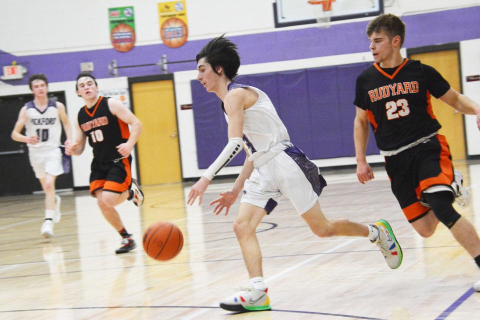 Pickford's Braylon Rounds (3) leads a fast break, while Rudyard's Austin Warner (23) chases during a EUPC boys basketball game Thursday night.