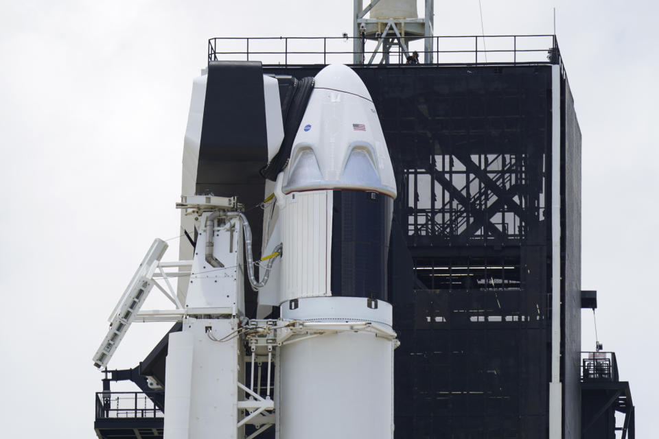 The SpaceX Falcon 9, with Dragon crew capsule on top of the rocket, sits on Launch Pad 39-A, Friday, May 29, 2020, at the Kennedy Space Center in Cape Canaveral, Fla. Two astronauts will fly on the SpaceX Demo-2 mission to the International Space Station scheduled for launch on Saturday, May 30. For the first time in nearly a decade, astronauts will blast into orbit aboard an American rocket from American soil, a first for a private company. (AP Photo/David J. Phillip)