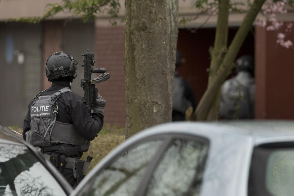 Dutch counter terrorism stand guard as others raid a house in connection with the shooting. Source: AP