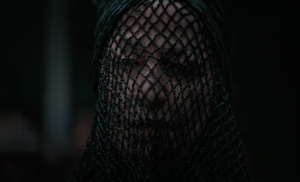 Charlotte in "Dune," she wears a black beaded fishnet veil over her face