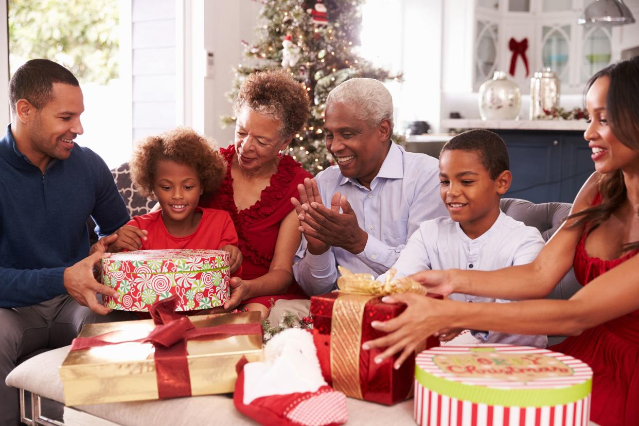 family with grandparents opening Christmas gifts