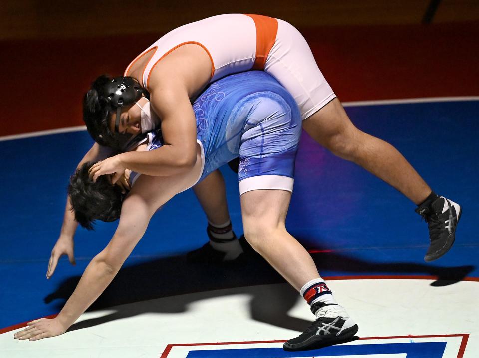 Wayland's Yaseen Nguyen goes for a ride on Ashland's Kevin Botsis during a 195 lbs. bout at Ashland Middle School, Jan. 13, 2021.  