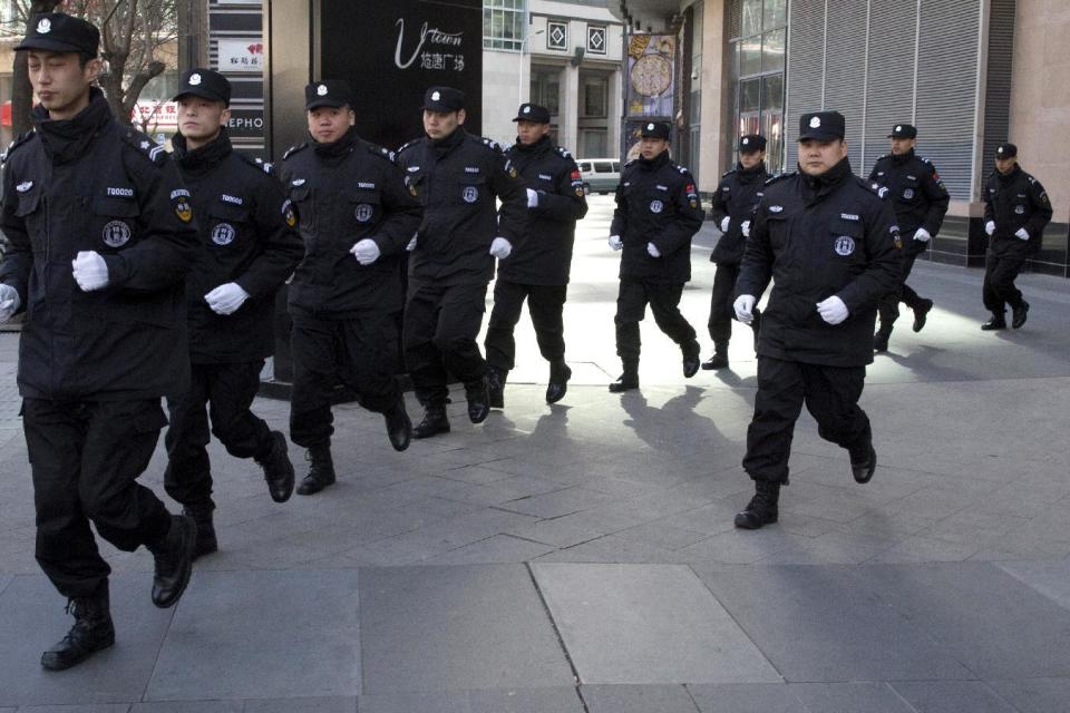 Security personnel are marshalled on duty as relatives of passengers onboard the missing Malaysia Airlines flight MH370 gather to demand for answers near the Foreign Ministry in Beijing, China, Wednesday, March 8, 2017. Wednesday marked the third anniversary of the disappearance of MH370, which vanished March 8, 2014 while en route from Kuala Lumpur to Beijing. (AP Photo/Ng Han Guan)