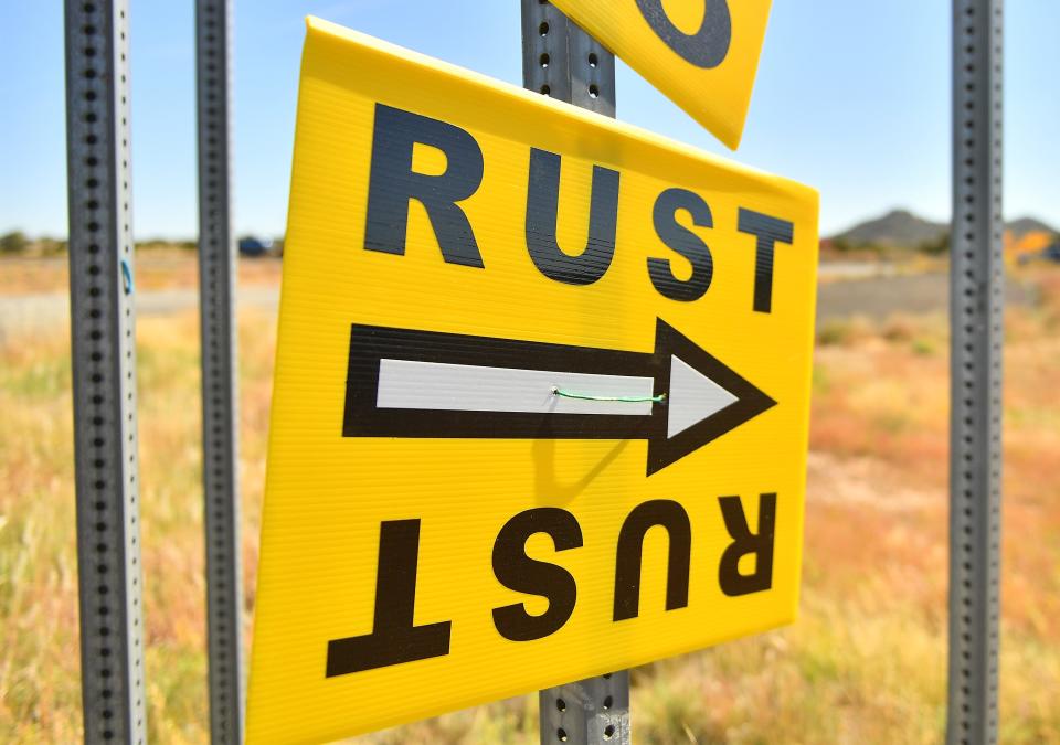 Yellow sign with white arrow with black boarder to set for the movie "Rust"