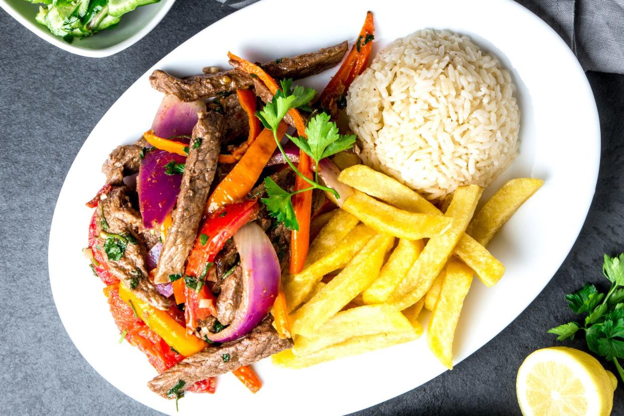 lomo saltado with fries and rice