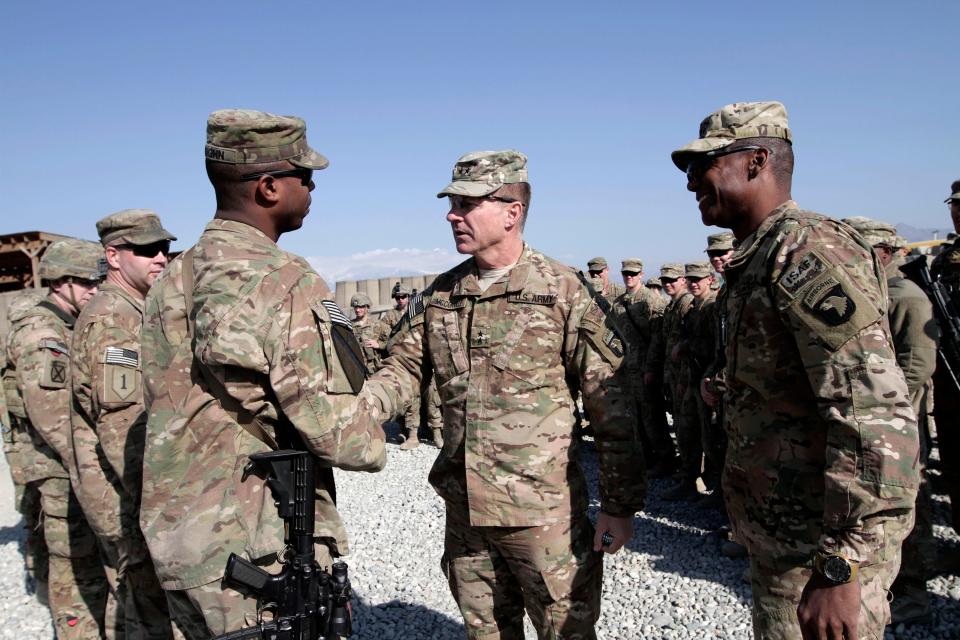 Lt. Gen. James McConville, center, visits troops in Afghanistan in 2013.