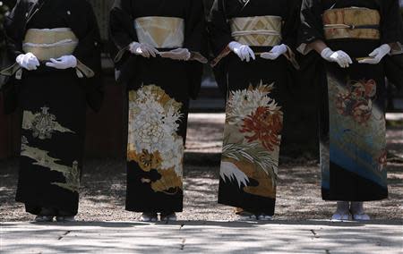 Women in kimonos stand at the Yasukuni Shrine during its Annual Spring Festival in Tokyo April 22, 2014. REUTERS/Yuya Shino