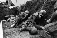 <p>US troops take cover from the Vietcong in a trench on Hill Timothy, during the Vietnam War. (Photo: Terry Fincher/Daily Express/Hulton Archive/Getty Images) </p>