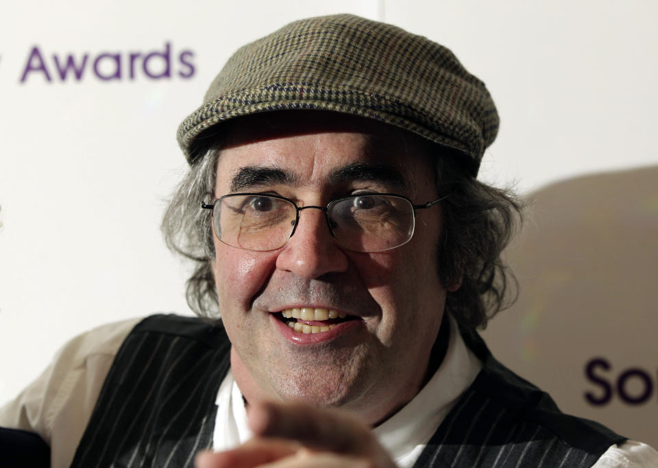 FILE - In this May 13, 2013 file photo, Danny Baker poses for a photo in London. A BBC DJ has been fired after using a picture of a chimpanzee in a tweet about the royal baby born to Meghan the Duchess of Sussex and her husband Prince Harry. Danny Baker tweeted Thursday, May 9, 2019 that he has been fired after posting an image of a couple holding hands with a chimpanzee dressed in clothes and the caption: "Royal baby leaves hospital." (Yui Mok/PA via AP, file)