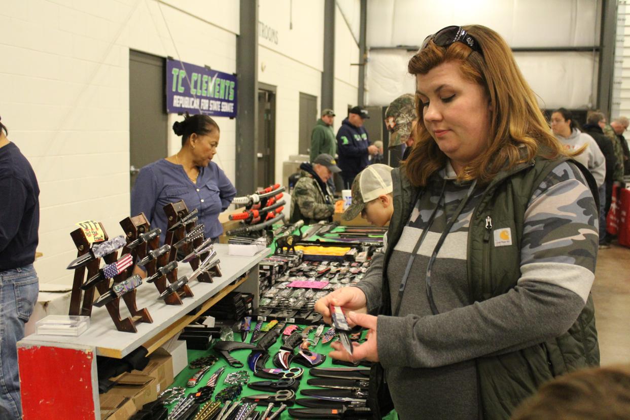 Cassi Winters of Ypsilanti looks at out-the-front knives, a gift to give her boyfriend for Valentine’s Day. She attended the Gun & Knife Show at the Monroe County Fairgrounds. Provided by Kennedy Bowling