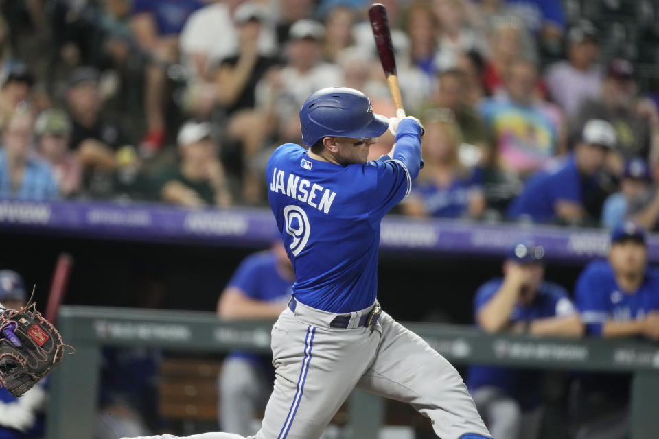 Toronto Blue Jays' Danny Jansen connects for a two-run home run off Colorado Rockies starting pitcher Chris Flexen in the fifth inning of a baseball game Friday, Sept. 1, 2023, in Denver. (AP Photo/David Zalubowski)