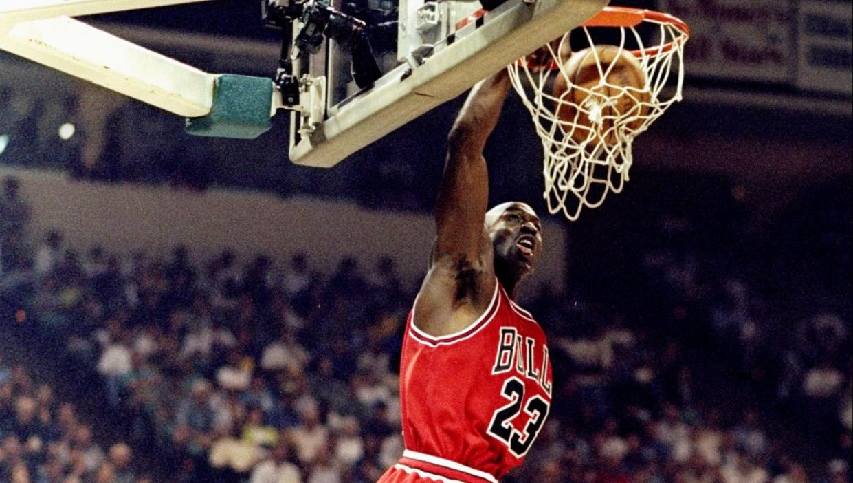 8 May 1998: Michael Jordan #23 of the Chicago Bulls slam dunks during the Eastern Conference Semifinals against the Charlotte Hornets at Charlotte Coliseum in Charlotte, North Carolina. Credit: Erik Pere